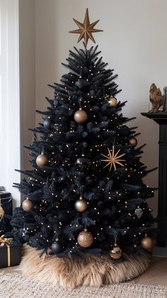 a black christmas tree decorated with gold ornaments