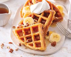 waffles topped with bananas and whipped cream