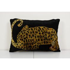 a black and yellow pillow with a leopard on it