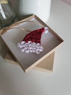 an ornament made out of rolled paper in a box