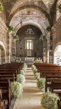 an image of the inside of a church with pews and flowers on it's side