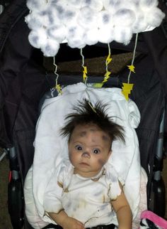 a baby is sitting in a stroller with some hair on it's head