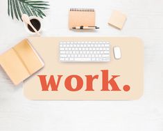 the word work is written on a mouse pad next to a keyboard and other office supplies