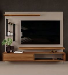 an entertainment center with a flat screen tv mounted on the wall