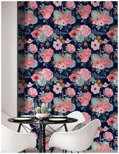 two chairs and a table in front of a floral wallpaper