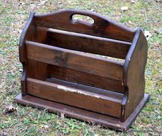 an old wooden magazine rack sitting in the grass