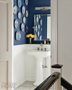 a bathroom with blue and white plates on the wall