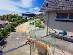 a house with a glass railing on the side of it