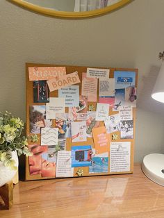 a bulletin board with pictures and notes on it sitting next to a vase filled with flowers