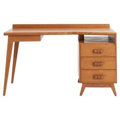 a wooden desk with three drawers on it