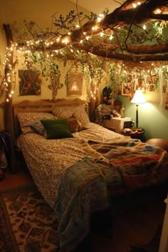 a bedroom with lights strung from the ceiling and a bed covered in blankets on top of it