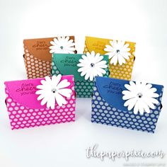 six different colored cards with white flowers on them