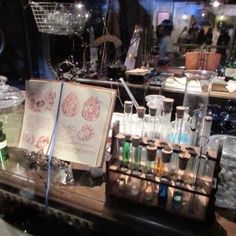 an assortment of laboratory equipment sitting on top of a counter in a store front window