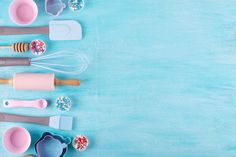 various kitchen utensils lined up on a blue surface