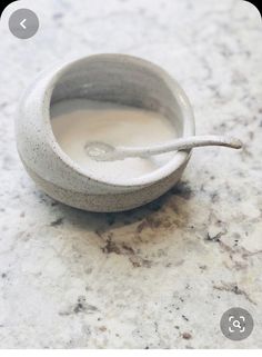 a small white bowl with a spoon in it