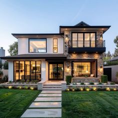 a modern house with steps leading up to the front door