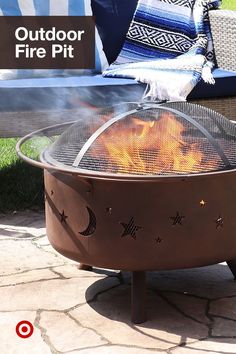 an outdoor fire pit sitting on top of a stone patio