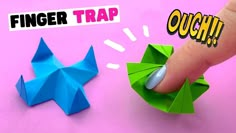 an origami finger trap is being held by someone's hand with the word finger trap on it