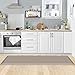 a kitchen with white cabinets and wooden floors