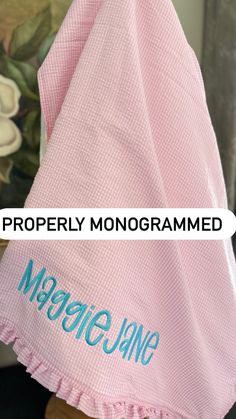 a pink towel with the words properly monogrammed on it