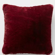 a red pillow on a white wall