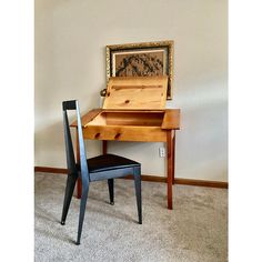 a wooden desk with a chair next to it