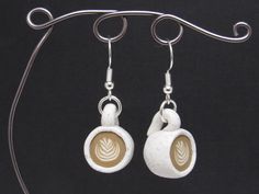 there is a pair of earrings with coffee in it