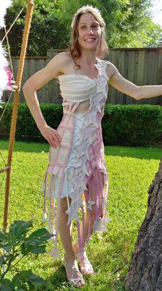 "RECYCLE WEDDING DRESS - TP AND TAPE - WOMEN'S DRESS - size EXTRA SMALL/SMALL 'NORTHERN LIGHTS' Made entirely with Quilted Northern toilet paper, all sorts of tape and some glitter glue! (No sewing or thread!) This dress was made April of 2019 for the \"Quilted Northern Wedding Dress Competition.\" The top is one-shoulder and laces up at center bust.  Botton half is connected. The skirt is very stiff, almost like wearing a cast.  Stars are hanging from ruffle strips at hem.  Wrap dress around body and lace up!  *DRESS IS FOR LIMITED WEARING ONLY, CANNOT SIT OR USE TALL STAIRS!* One matching accessory: star head band  Mannequin Measurements: BUST: 33.5\" UNDERBUST: 27.5\" WAIST: 26\" HIPS: 37\" *Item fits a women's size xs-small* Model Measurements: Bust: 32A Waist: 25\" Hip: 36\" Height: 5 Recycle Wedding Dress Ideas Projects, Northern Wedding, Recycle Wedding Dress, Sparkle Stars, Book Clothes, Glitter Glue, Matching Accessories, Dress Clothes For Women, Pink And White