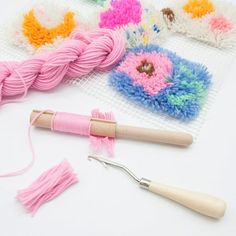 yarn and crochet tools are laying on a white surface, including a knitting needle