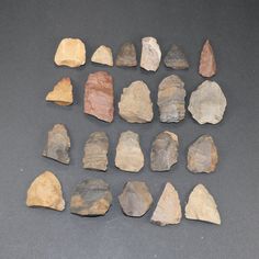 a group of rocks sitting on top of a black table next to each other in different shapes and sizes