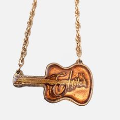 Vintage Elvis Presley "King of Rock" Guitar Pendant Necklace 24" Chain, Rare * Elvis Presley "King of Rock" guitar pendant necklace * Unique design capturing the essence of Elvis Presley * Vintage collectible from early 1977, originally created for concert sales * Limited production; scrapped after Elvis's passing * Chain length: 24 inches * Charm measures 3.5" x 2.5" * Gold-toned finish with a shiny Yellow inset on the guitar * Perfect for Elvis fans and collectors of music memorabilia * Great addition to any rock and roll or pop music collection * Vintage condition with minor wear due to age * Striking and sharp look, ideal for showing admiration for the King of Rock and Roll  This item has been in my late parents collection since they originally purchased it in the 70s. It was put in st Elvis Presley Jewelry, Elvis Merch, Elvis Jewelry, King Of Rock And Roll, Guitar Pendant, Rock Vintage, Rock Guitar, Necklace Unique, Accessories Jewelry Necklace