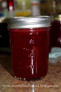 a glass jar filled with red liquid sitting on top of a counter