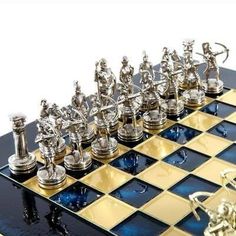 a chess board with silver and gold pieces on it