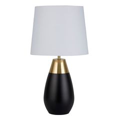 a black and gold table lamp with a white shade on the top, against a white background