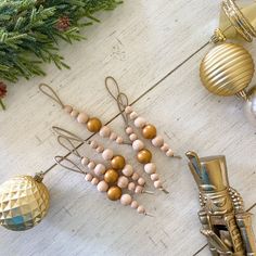 some ornaments are laying on the floor next to christmas tree branches and pineconis