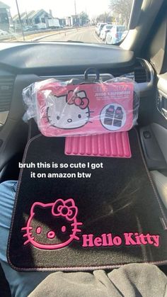 hello kitty car mats in the back seat of a car, with an ad on it