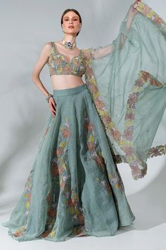 Dusty green can can attached lehenga featuring floral applique patterns highlighted with cutdana. Comes with padded blouse and dupatta.
Components: 3
Pattern: Embroidered
Type Of Work: Floral, Thread, Cutdana, Sequin
Neckline: Cut-out
Sleeve Type: Sleeveless
Fabric: Organza, Lining: Crepe
Color: Green
Other Details: 
Closure: Blouse and Lehenga: Side zip
Length:
Blouse: 13.5 Inches
Lehenga: 45 Inches
Model Height: 5 ft 9 Inches
Occasion: Sangeet,
Reception - Aza Fashions Applique Work Lehenga, Embroidered Lehenga Designs, Aza Fashion Lehenga, Lehengas Designs, India Traditional Dress, Light Green Blouse, Carnival Outfit, Lehenga Pattern, Cocktail Party Outfit