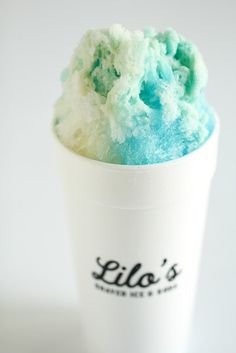 a white cup filled with blue and green ice cream