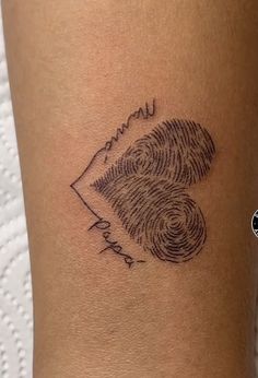 a woman's arm with a fingerprint tattoo on it