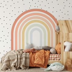 a child's bedroom with a rainbow wallpaper and wooden bed frame in the foreground