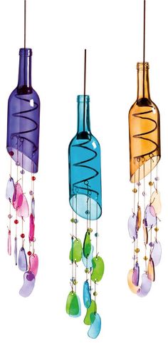 three wine bottles hanging from the ceiling with beads and glass drops attached to each bottle