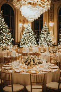 the tables are set with white and gold decorations