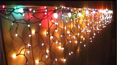 christmas lights are hanging on the wall