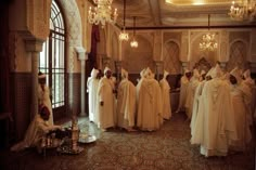 a group of people dressed in white robes