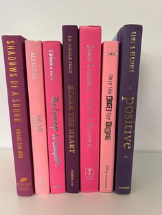 a row of books sitting on top of a white table