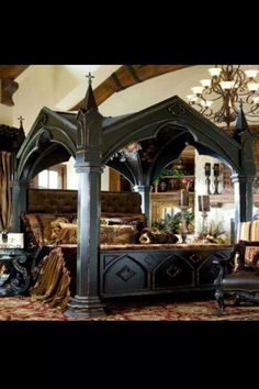 a bedroom with a canopy bed and chandelier