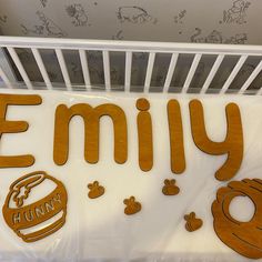 a crib with wooden cutouts that spell out the word,'family '