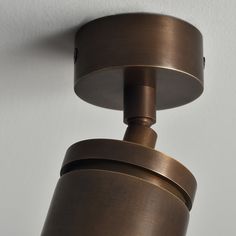 a close up of a light fixture on a wall in a room with white walls