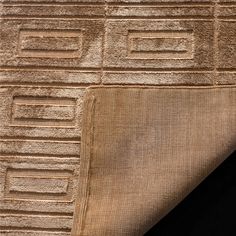 a close up view of a rug with different colors and patterns on it's surface