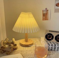 a lamp that is sitting on top of a table next to some books and other items